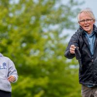 Bryan Bickford throws a bag and smiles
